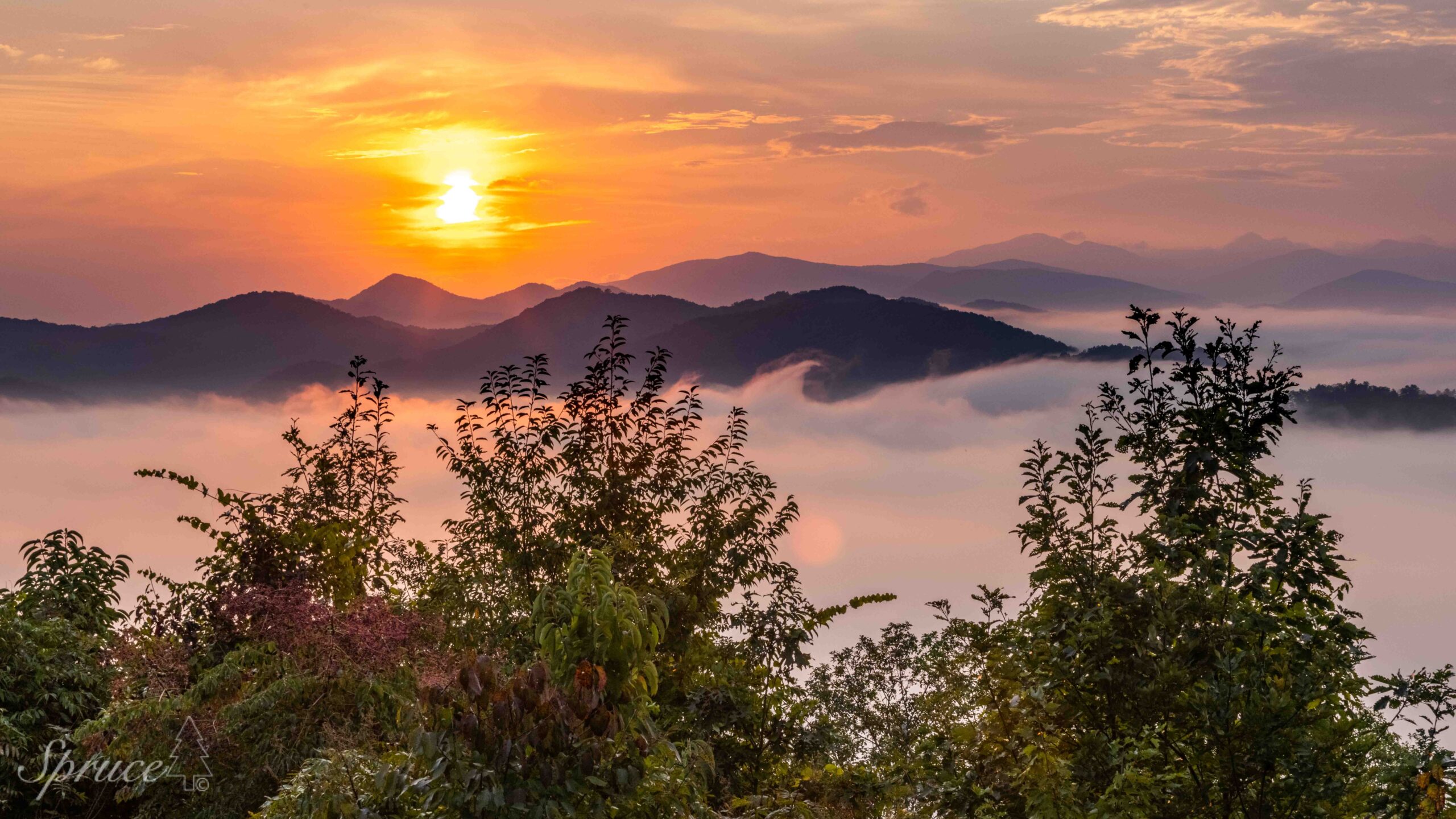 Sun rising over Smoky Mountains with fog filling the valleys.
